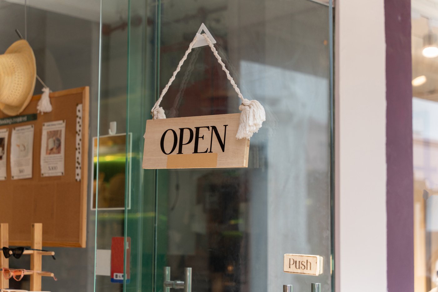 A business sign that says âOpenâ on local businesses hang on